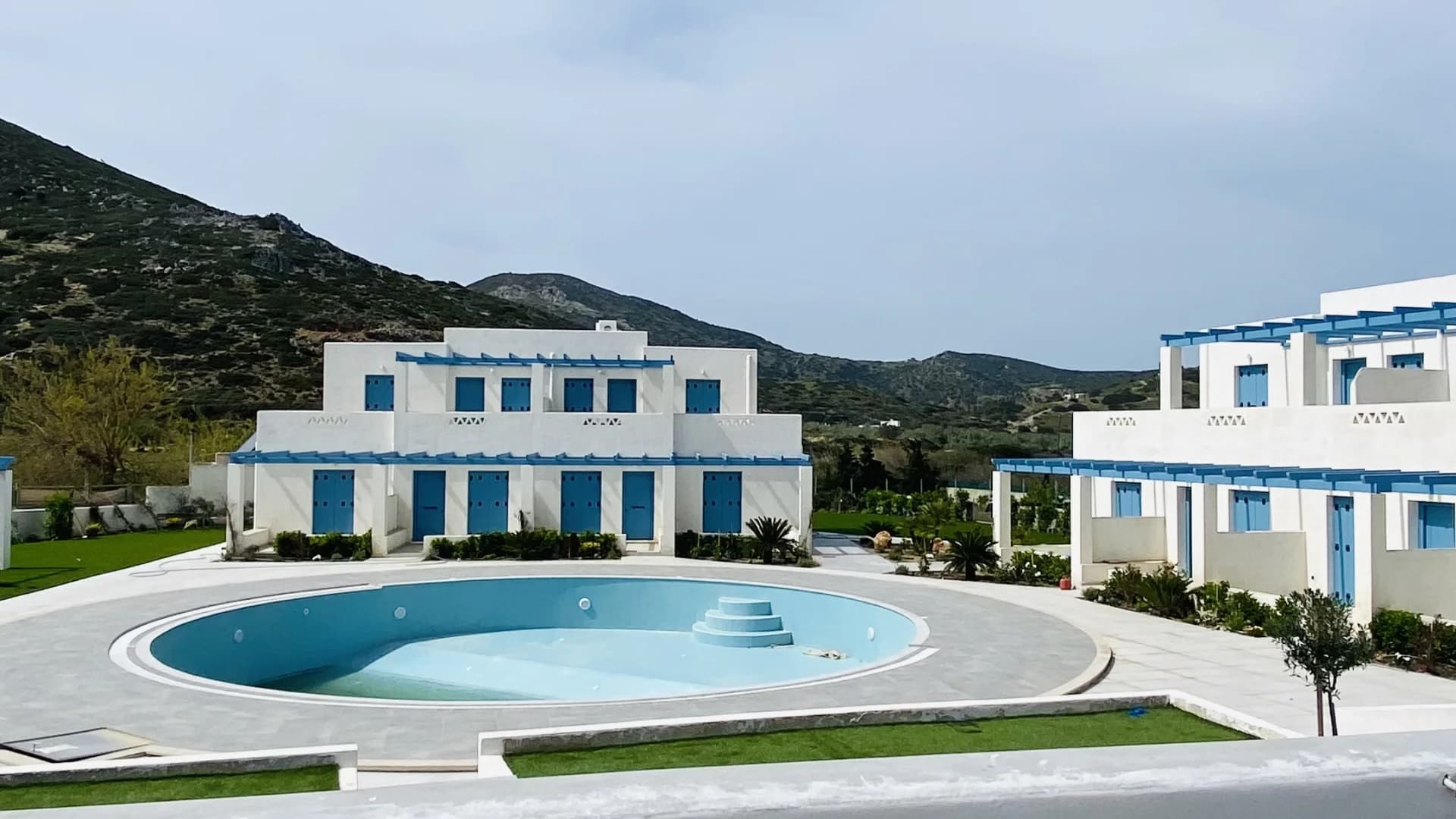 Πολυτελές Συγκρότημα Δωματίων Μορφέας - Πισίνα και κτίρια με φόντο τα βουνά
